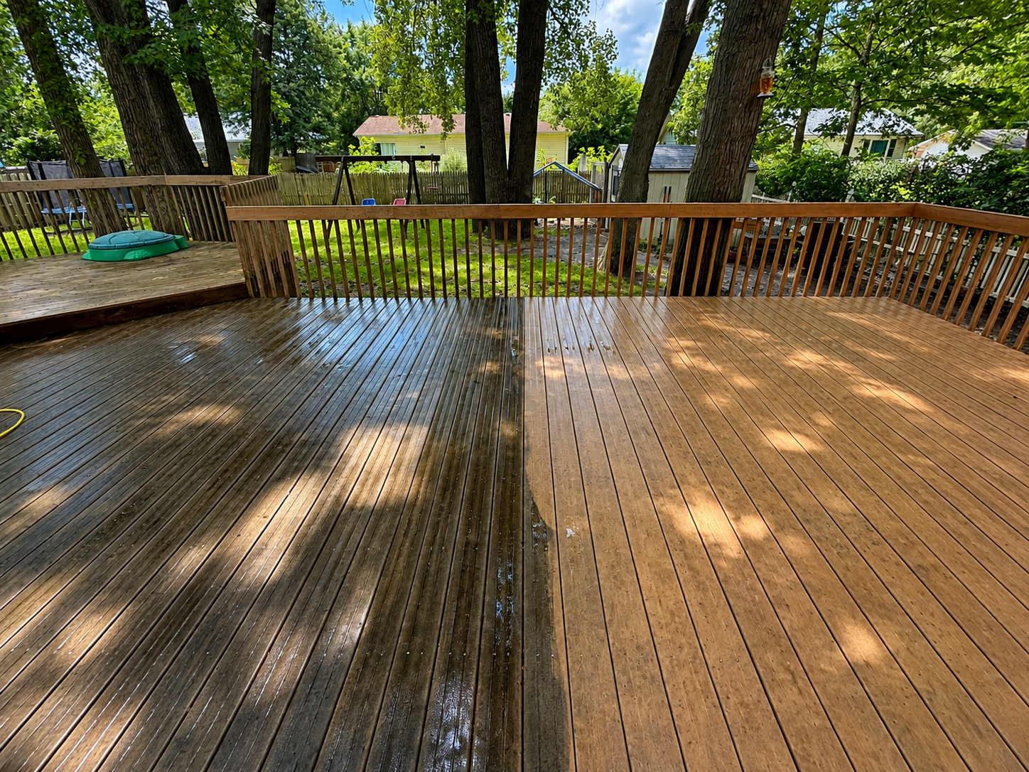 Backyard deck during cleaning showing the contrast between dirty and washed wood